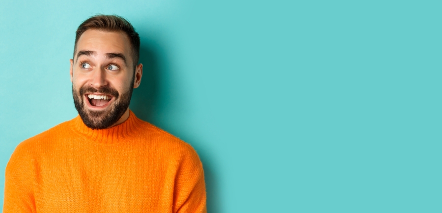 closeup-handsome-caucasian-man-smiling-looking-left-with-surprised-face-staring-logo-wearing-o